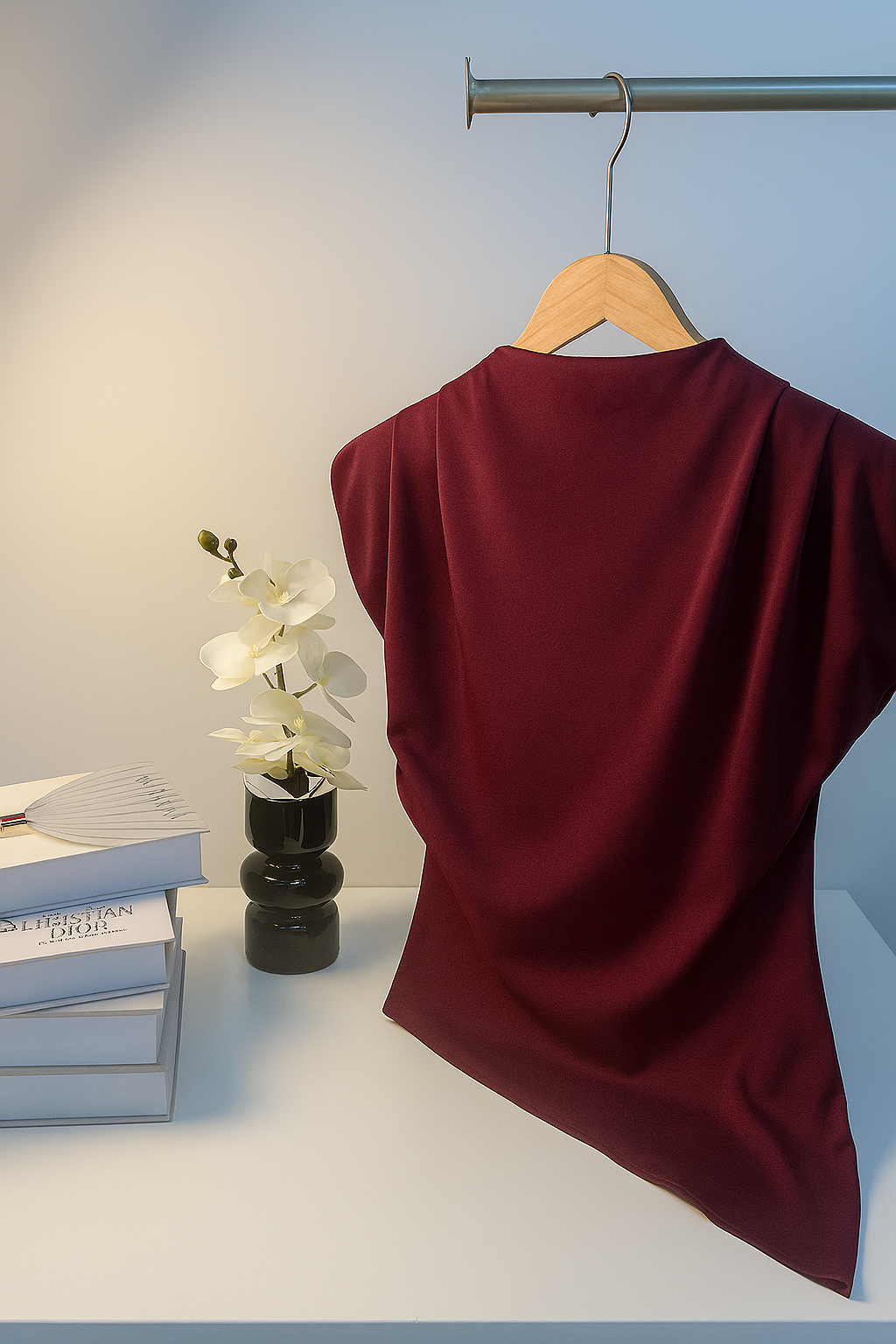 Wine red top on a hanger with a minimal background