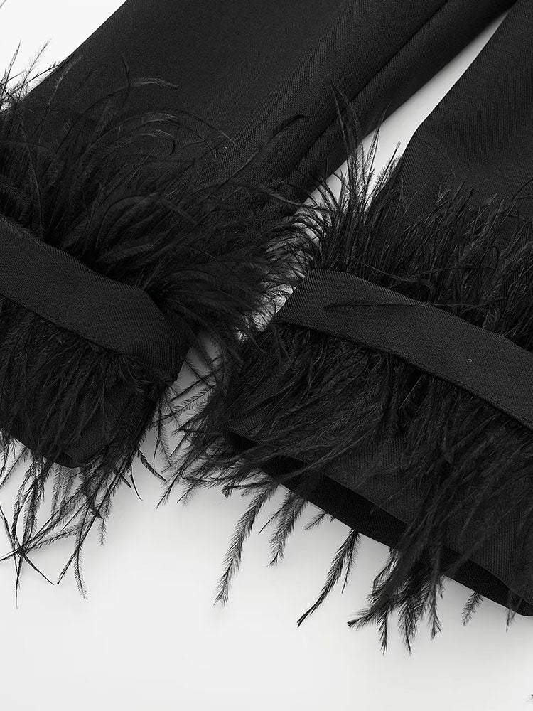 Detailed view of feather trim on cuff of black oversized blazer by Noir by Lina, adding texture and statement flair