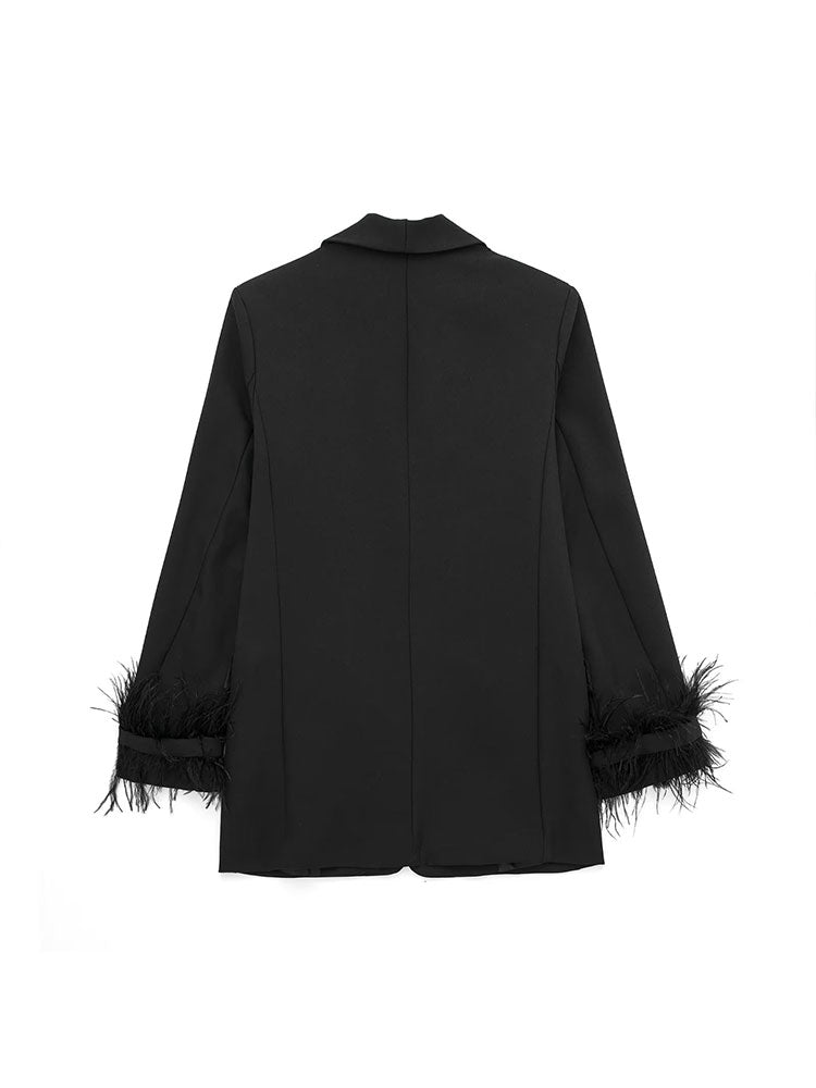 Back view of black oversized blazer with feather-trimmed cuffs, structured shoulders, and clean seam lines by Noir by Lina