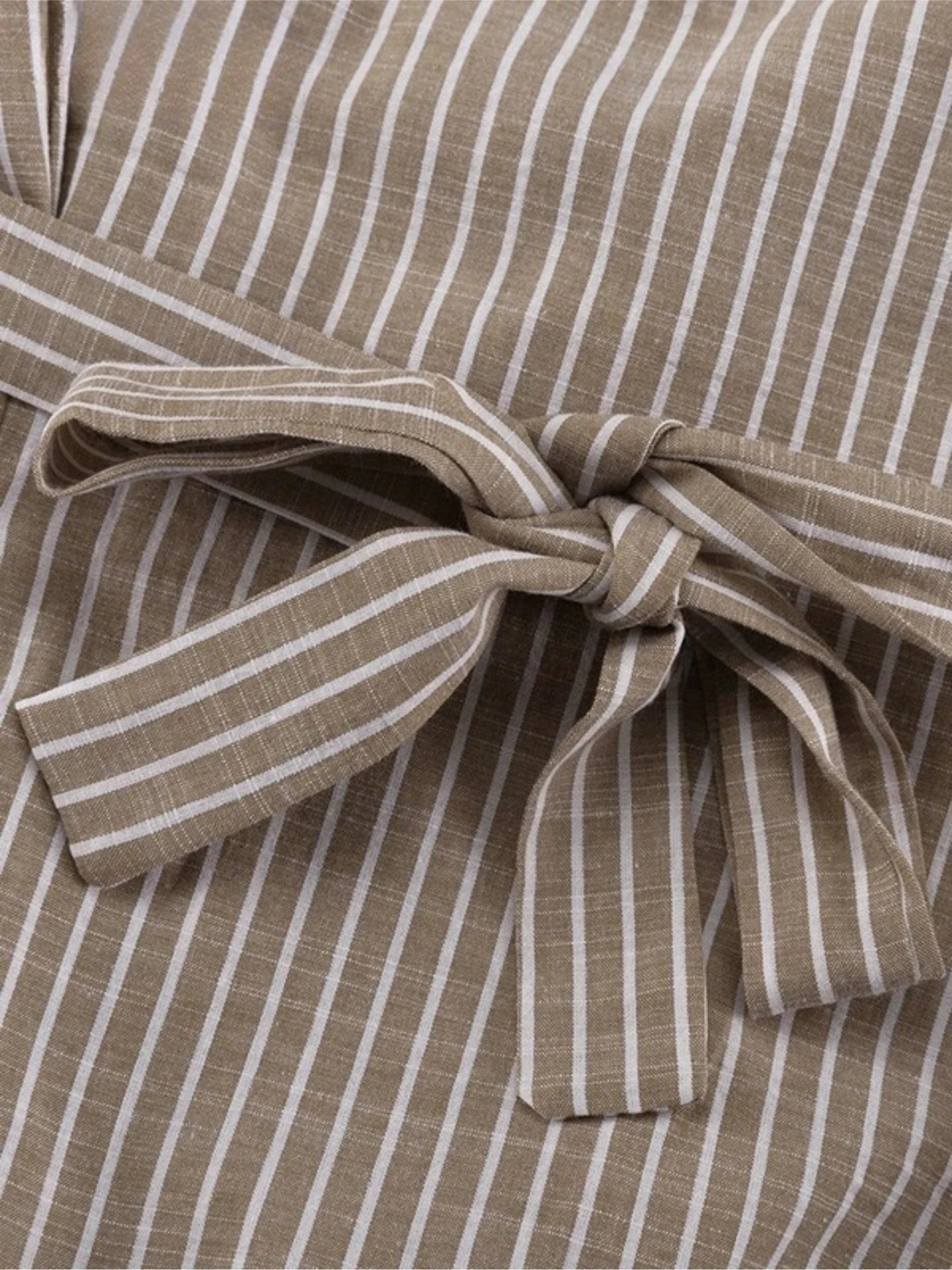 Close-up of a brown and white striped fabric with a bow