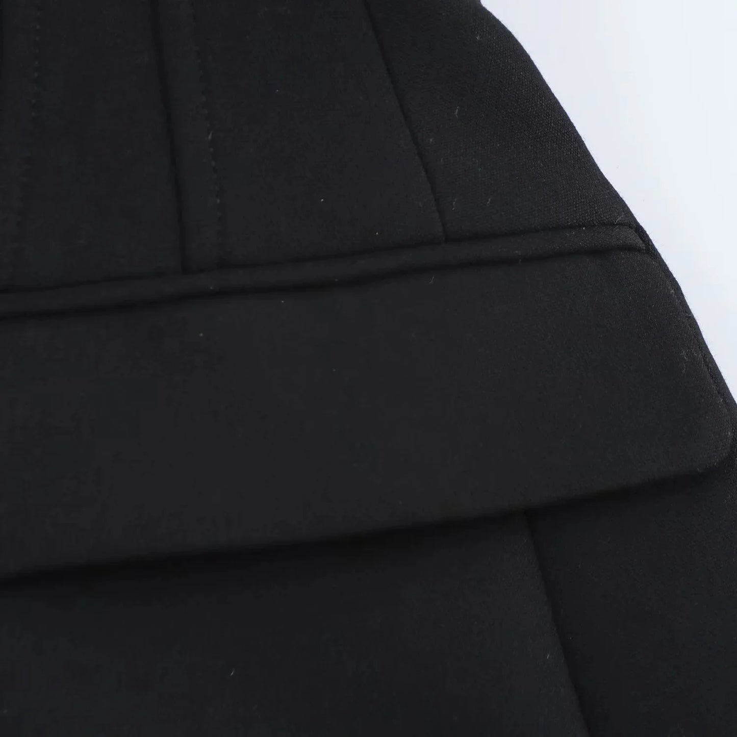 Close-up of structured flap pocket and stitching on black Valencia Power Suit blazer by Noir by Lina