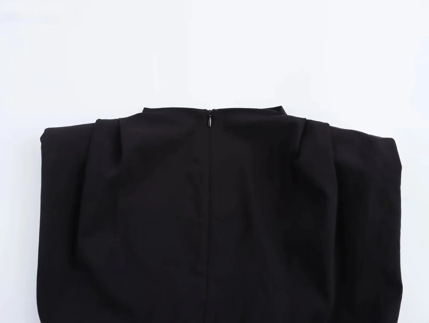 Black top with a zipper on a white background