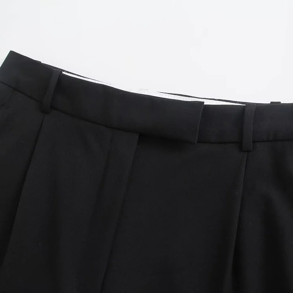 Detail of waistband and belt loops on black classic fit trousers by Noir by Lina