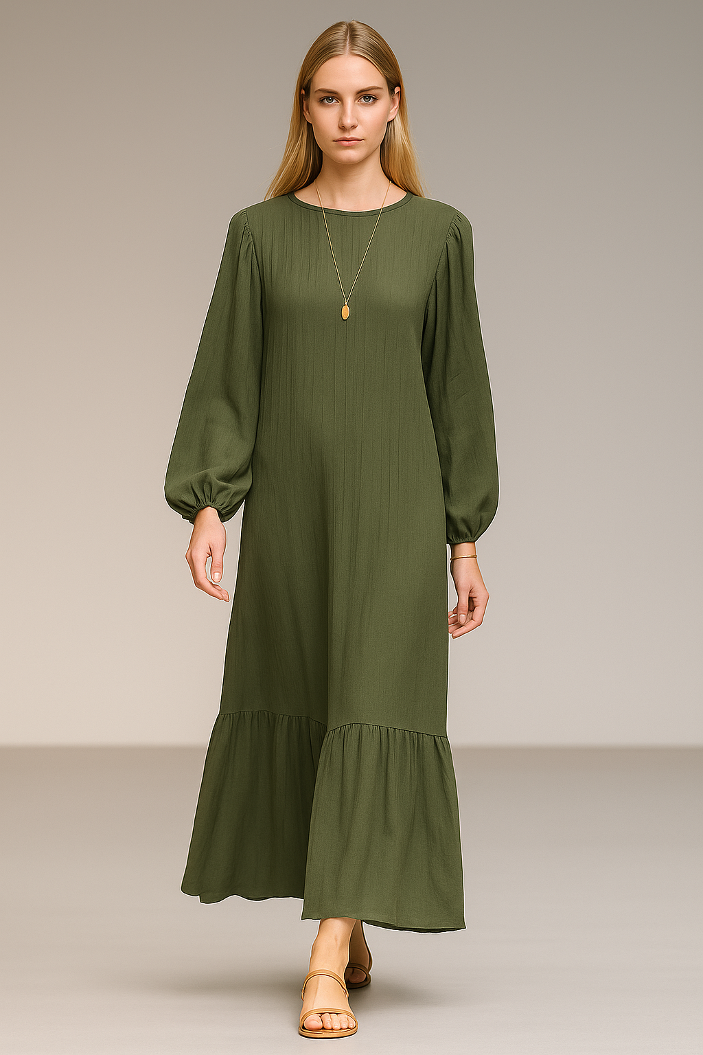 Blonde model in her 20s walking a runway in an army green maxi dress with puff sleeves, ruffled hem, and flat sandals.